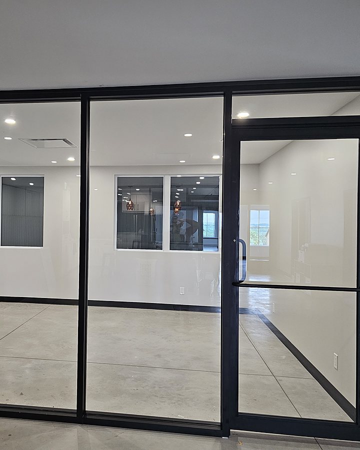 Cloisons vitrées et porte de verre d'un espace commercial, parfaitement transparentes après le lavage OMAX